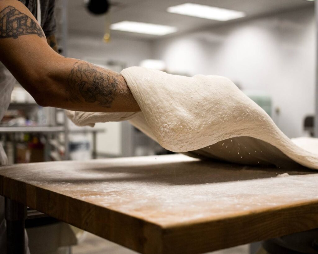 Pizza chef throwing dough.